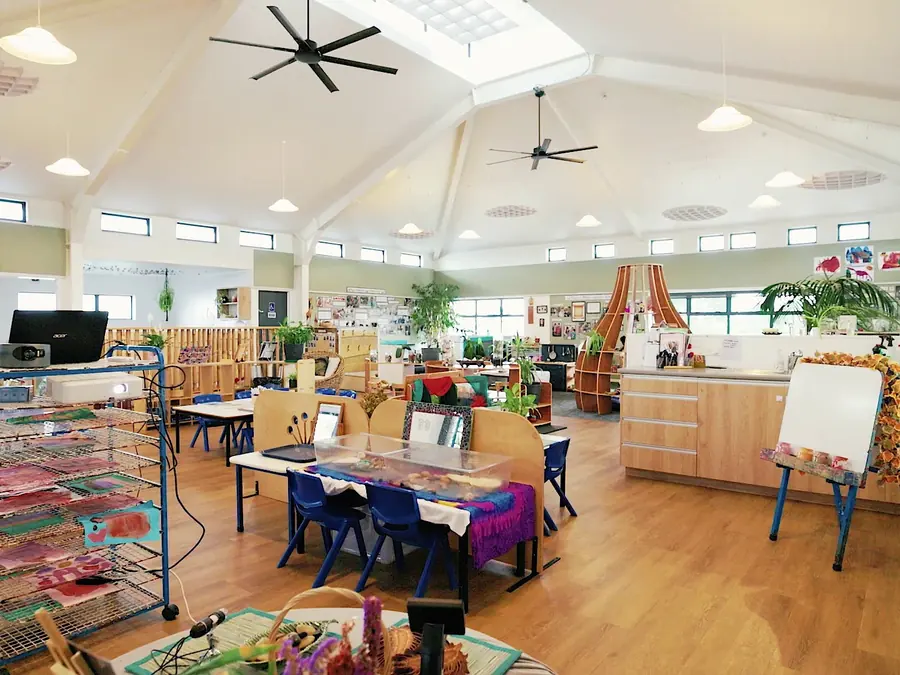 The main hall at Northcross, with a vaulted ceiling, skylights, low tables and an easel.