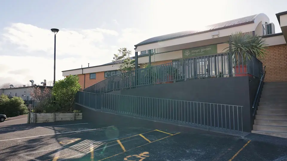 The centre building from the car park, with a ramp and railings up to its deck.