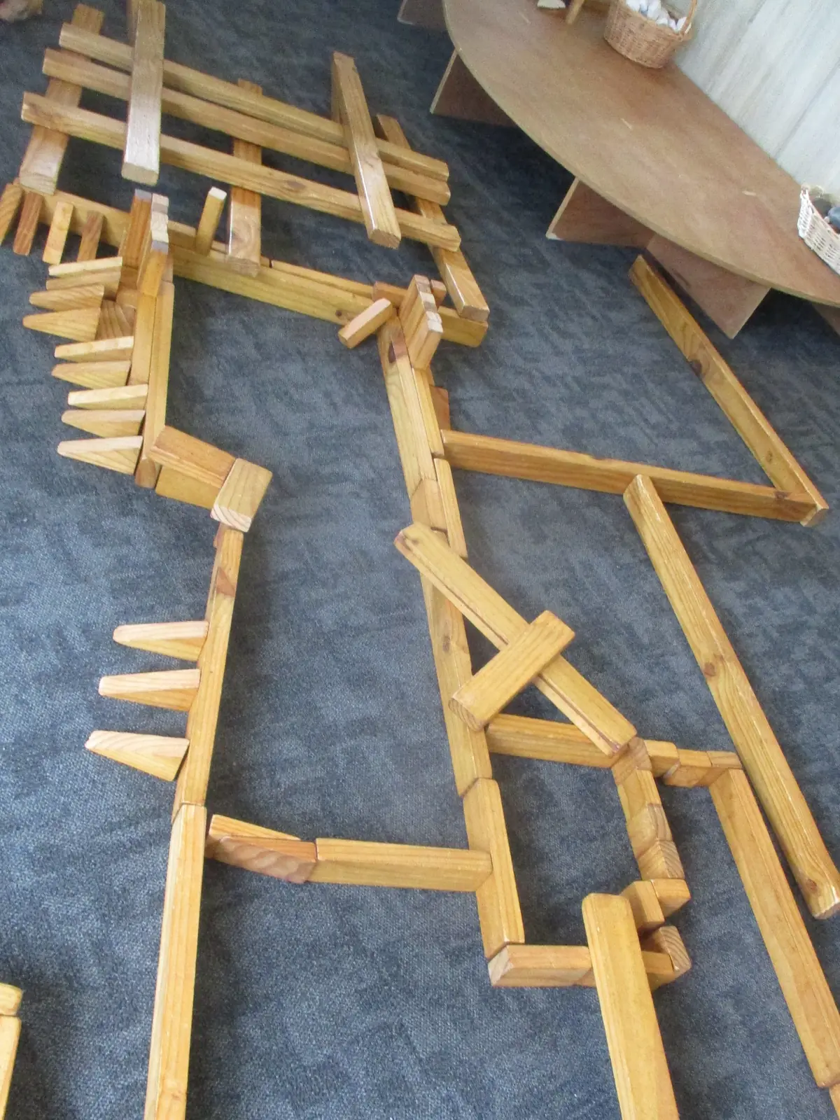 A maze of wooden blocks on the carpet.