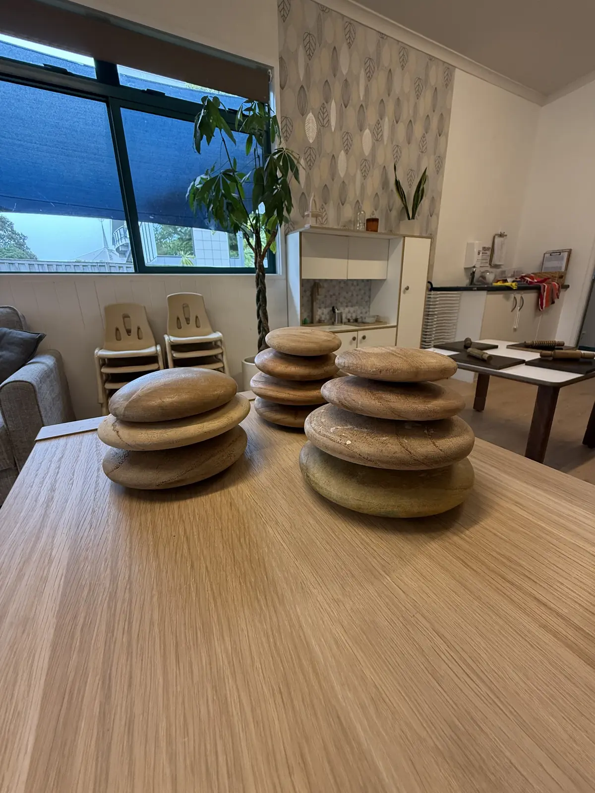 Smooth wooden stacking stones on a table.
